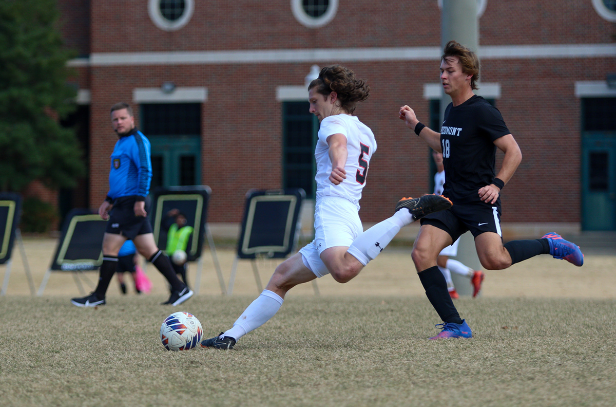 Man tossing soccer ball on field